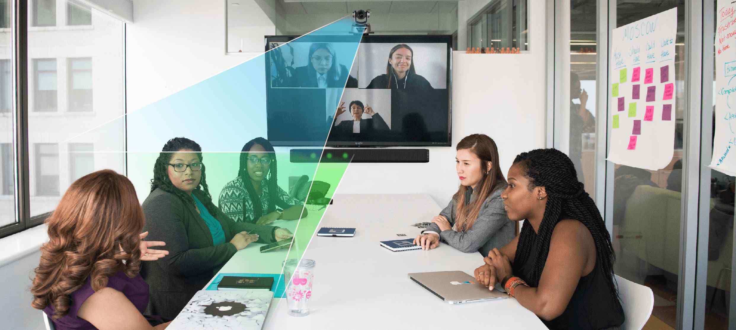 Women in a meeting using LeCAMBIO conference room audio video solutions